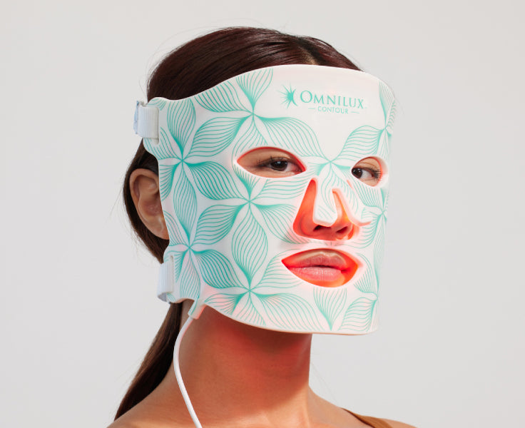 woman with Omnilux LED mask on her face
